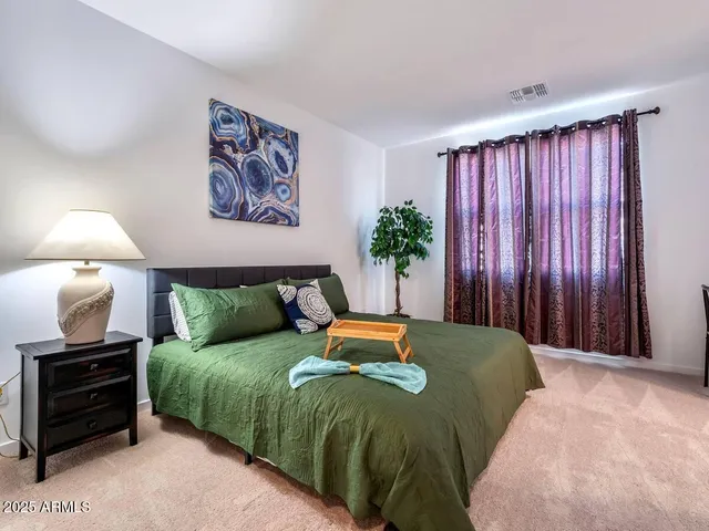 a bedroom with a bed and a view of wall painting