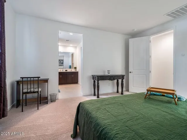 a bedroom with a bed and a table in it