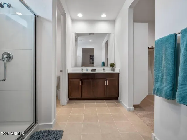 a bathroom with a sink a mirror and a shower