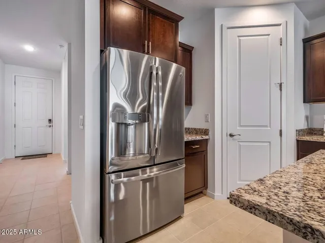 a kitchen with stainless steel appliances granite countertop a refrigerator and a sink