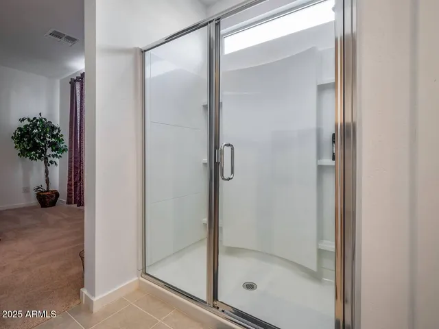a bathroom with a glass shower door