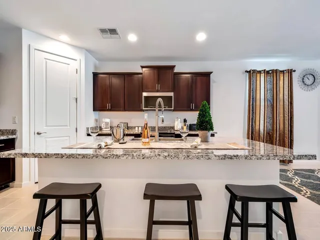 a kitchen with stainless steel appliances granite countertop a sink and cabinets