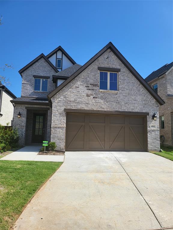 a front view of a house with yard and trees