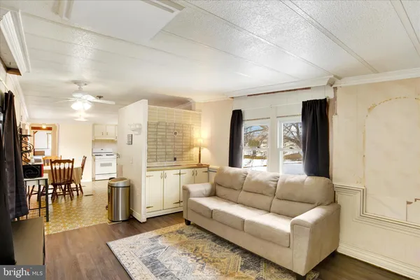 a living room with lots of furniture and a large window