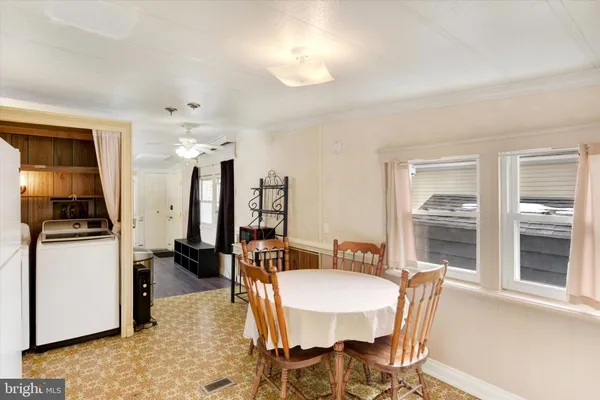 a dining room with furniture and window
