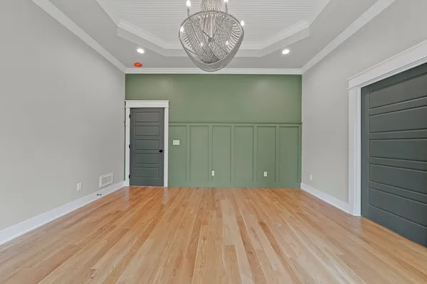 a view of a room with wooden floor