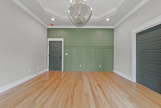 a view of a room with wooden floor