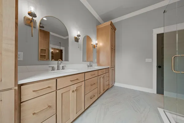 a bathroom with double sink and a mirror