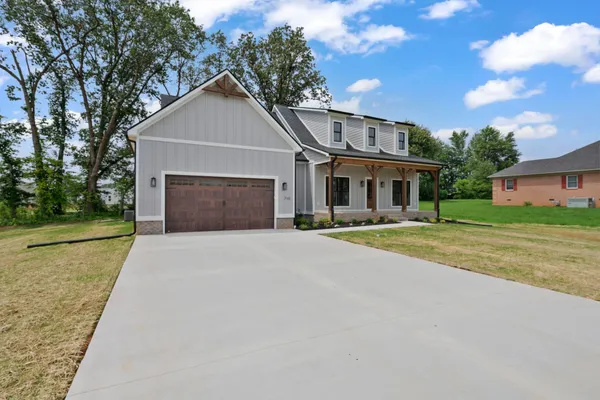 a front view of a house with a yard and garage