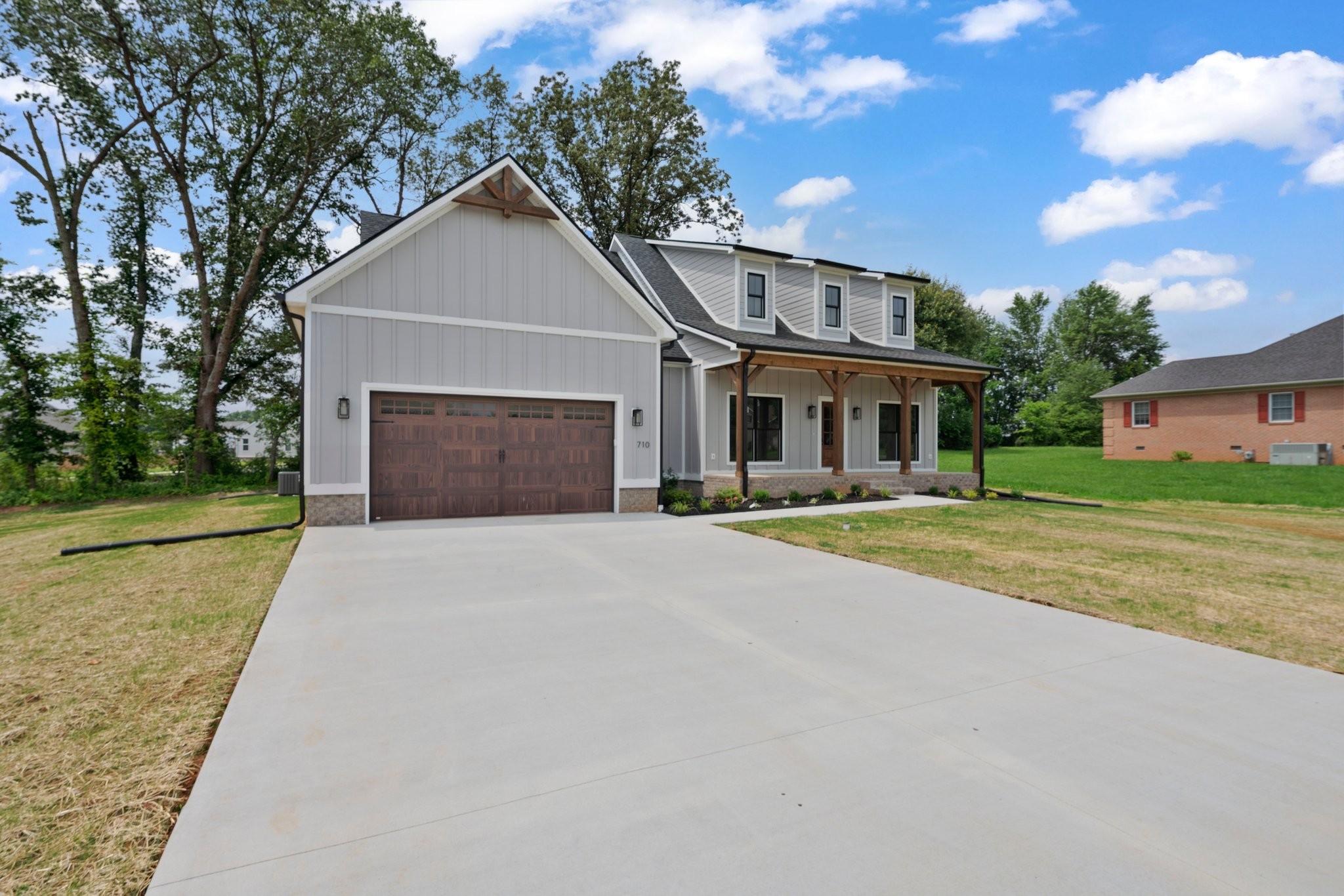 710 Rolling Rd Drive Franklin, KY 42134 - Photo 2 of 27 a front view of a house with a yard and garage