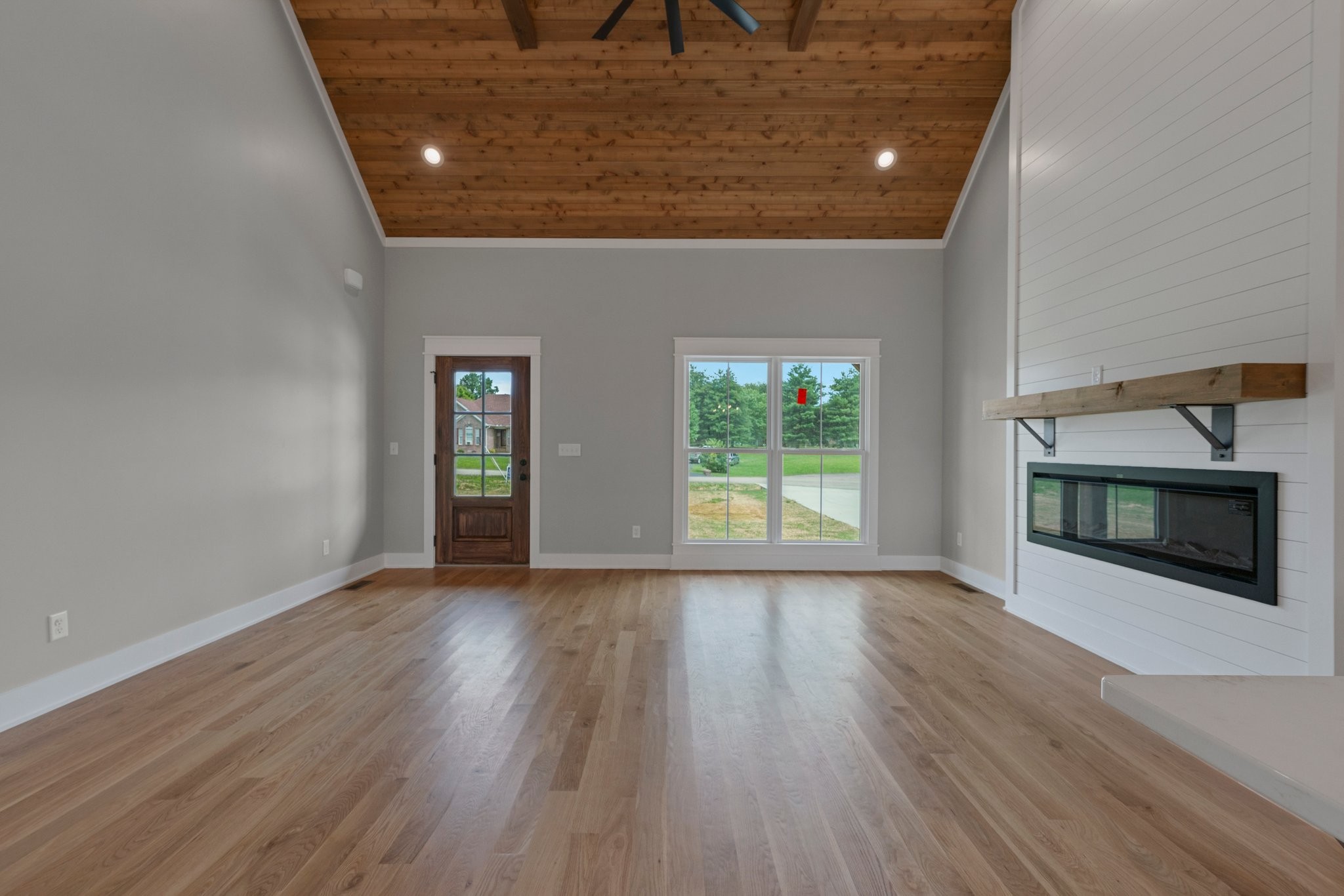 710 Rolling Rd Drive Franklin, KY 42134 - Photo 6 of 27 an empty room with wooden floor fireplace and windows
