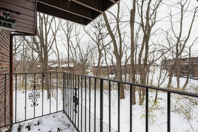 a view of wooden house with large trees