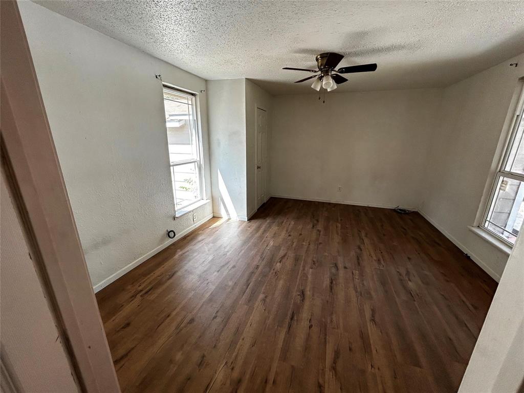 910 West Long, Unit A Stephenville, TX 76401 - Photo 26 of 39 wooden floor in an empty room with a window