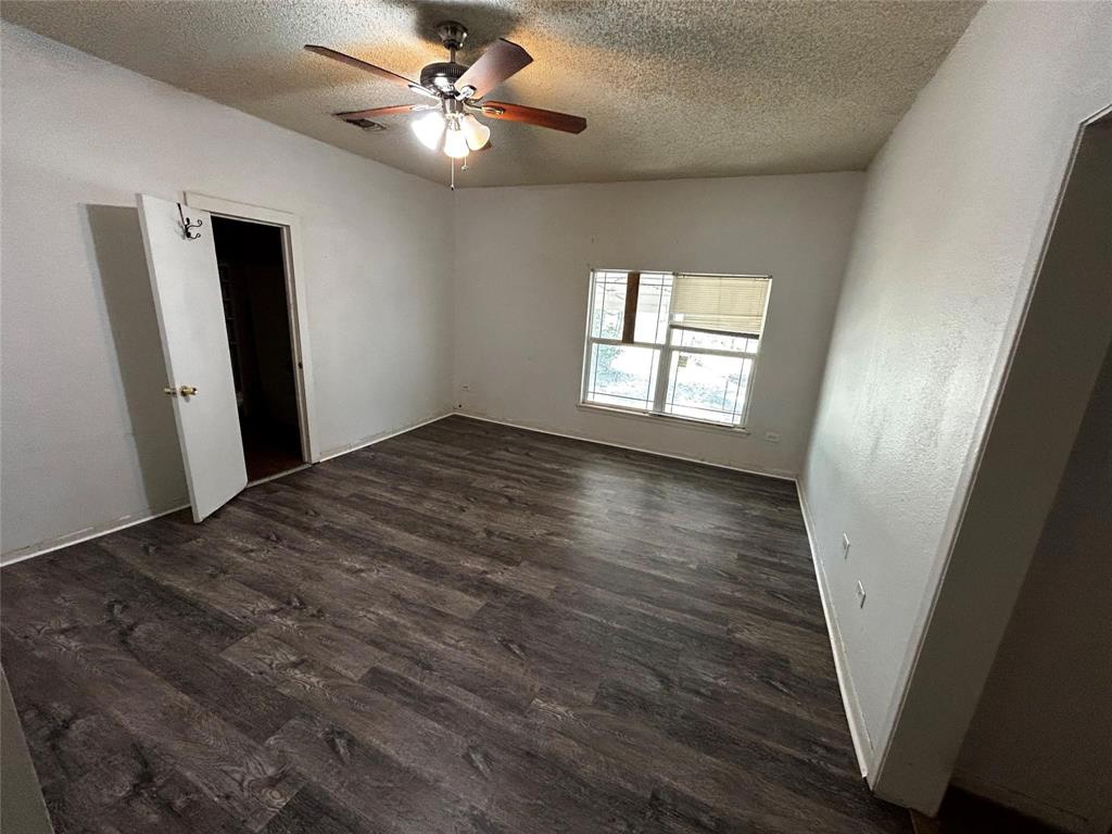 910 West Long, Unit A Stephenville, TX 76401 - Photo 28 of 39 wooden floor in an empty room with a window
