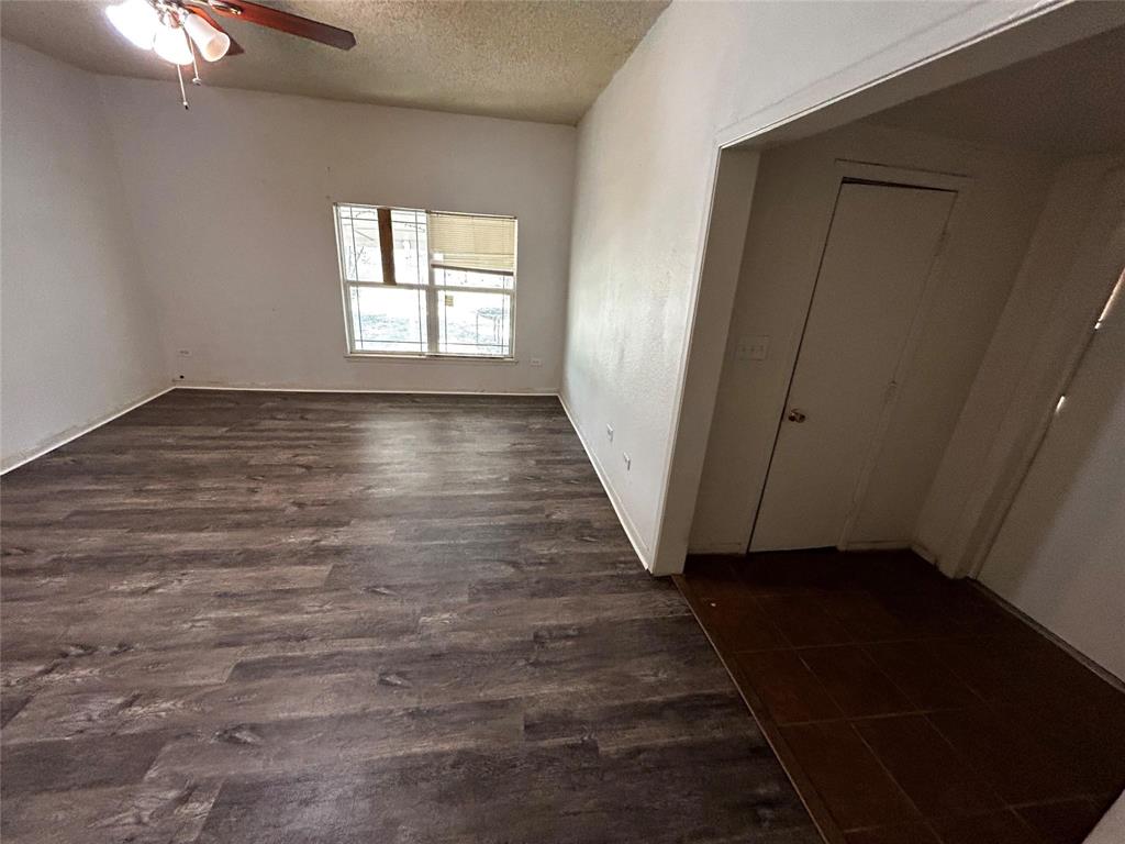 910 West Long, Unit A Stephenville, TX 76401 - Photo 29 of 39 an empty room with wooden floor and windows