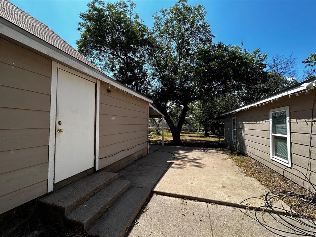 910 West Long, Unit A Stephenville, TX 76401 - Photo 37 of 39 a view of backyard with wooden fence and large trees