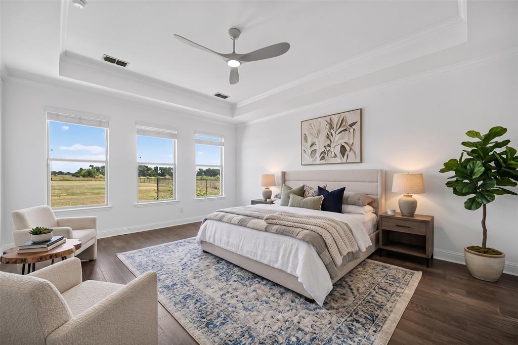 544 Gant Road Sherman, TX 75090 - Photo 19 of 39 Tray ceiling with crown molding, wood-finish flooring, three large windows, modern ceiling fan, and recessed lighting