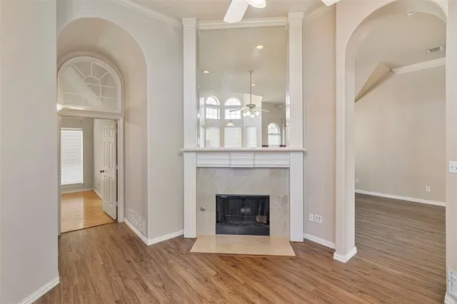 a view of a livingroom with wooden floor and a fireplace