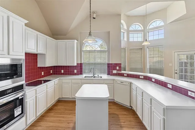 a kitchen with a sink stove and cabinets