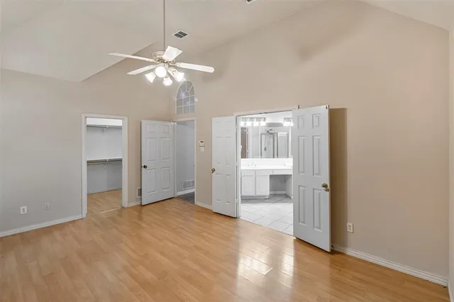 a view of a room with wooden floor and ceiling fan