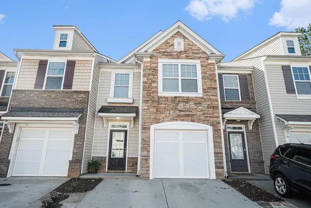 a front view of a house with parking space