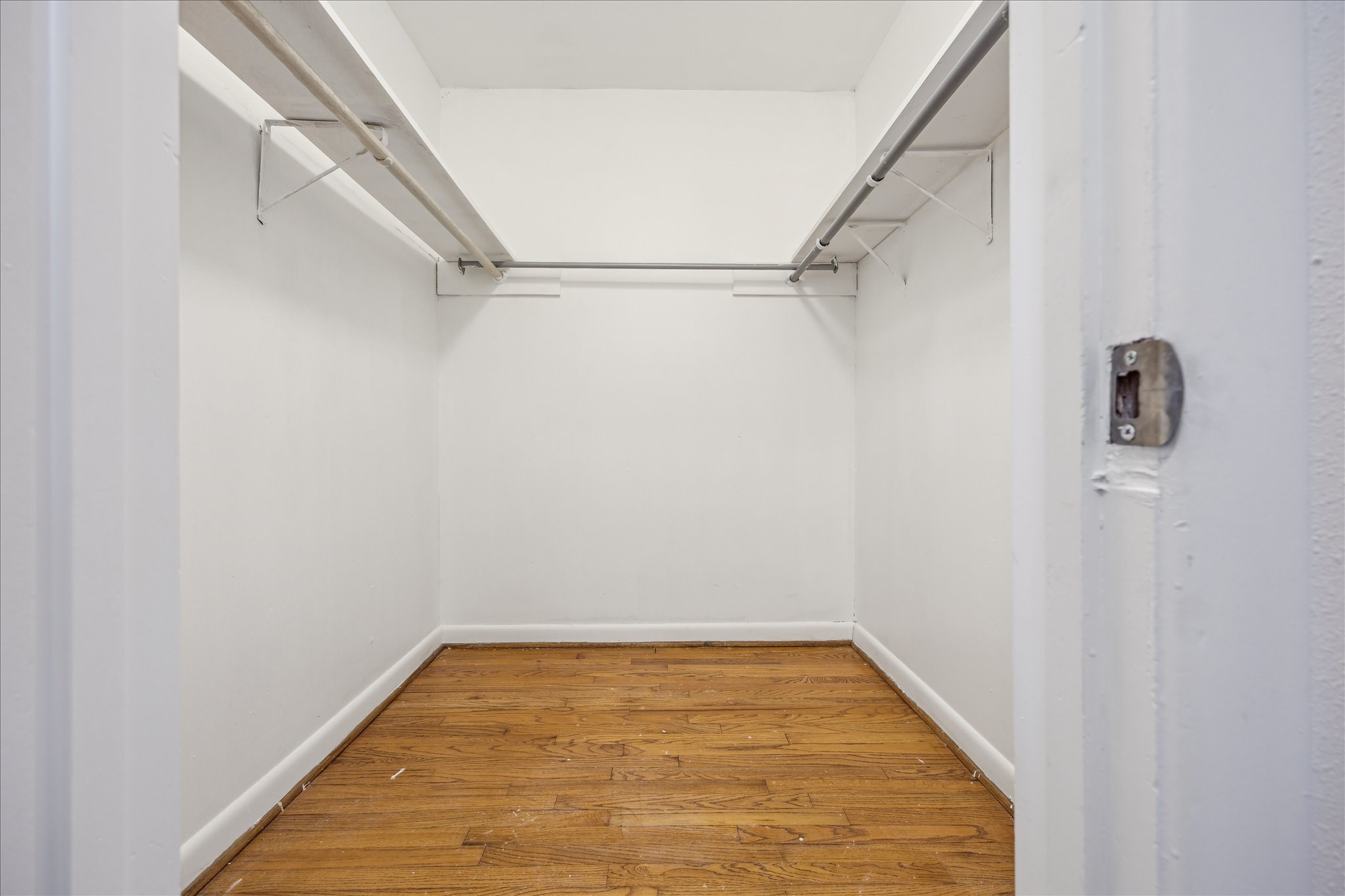 5419 Beechnut Street Houston, TX 77096 - Photo 21 of 28 Fantastic walk-in closet with dual hanging rods and wood flooring.