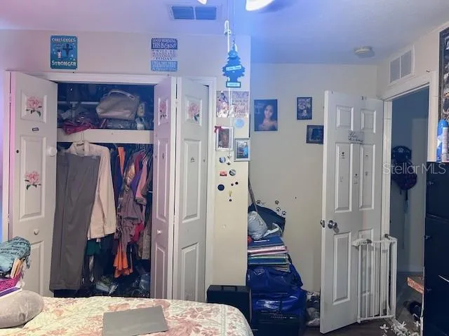 a view of a hallway with a bedroom and front door