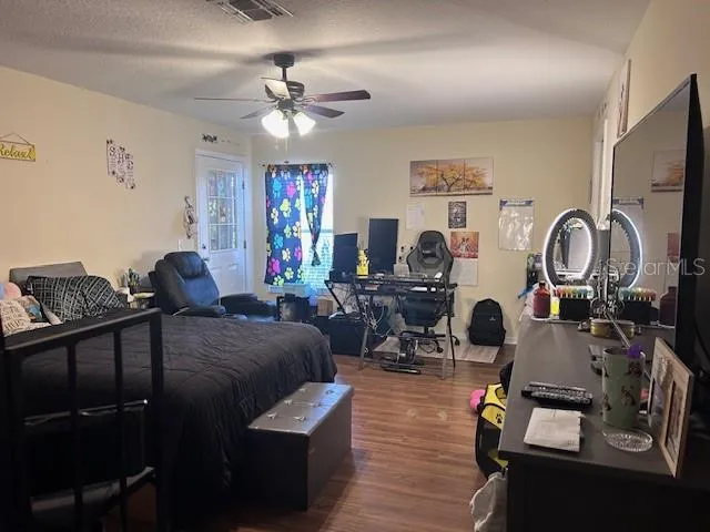a living room with furniture a flat screen tv and a mirror