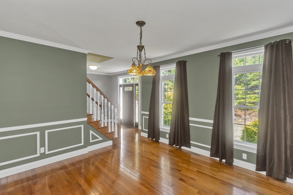 333 Stebbins Street Belchertown, MA 01007 - Photo 12 of 42 a view of a room with wooden floor staircase and windows
