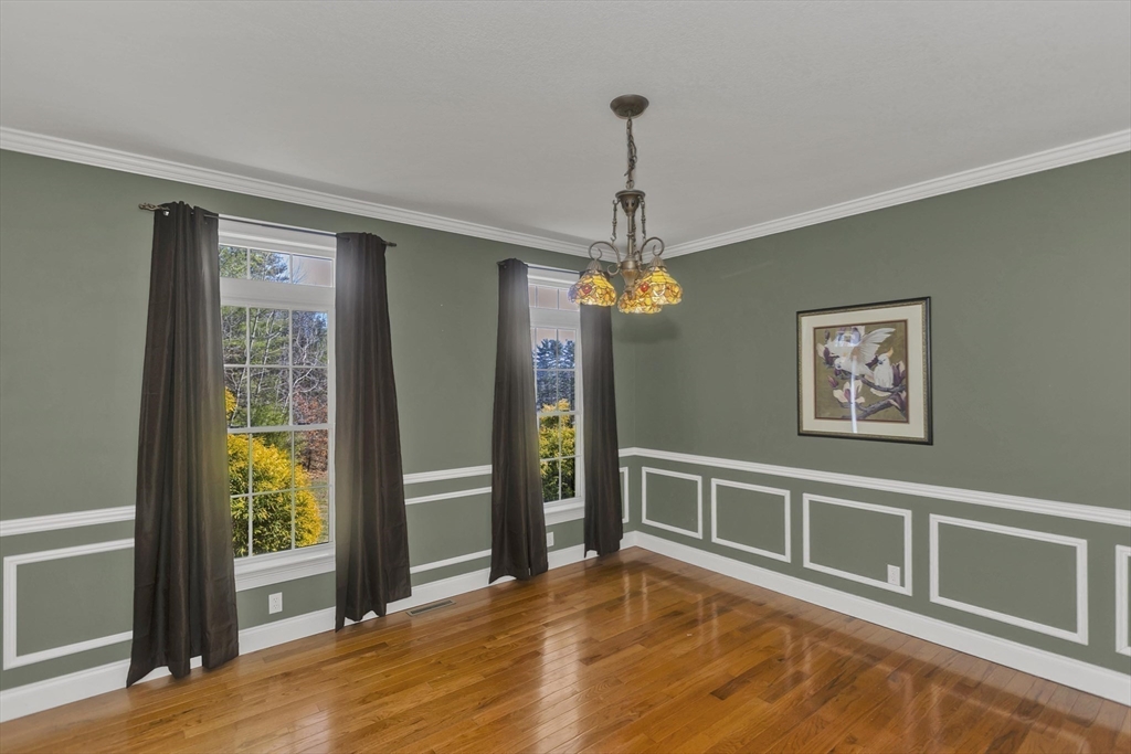333 Stebbins Street Belchertown, MA 01007 - Photo 13 of 42 a view of a livingroom with a chandelier wooden floor and front door