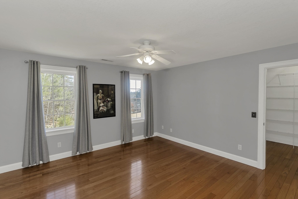 333 Stebbins Street Belchertown, MA 01007 - Photo 23 of 42 an empty room with wooden floor and windows