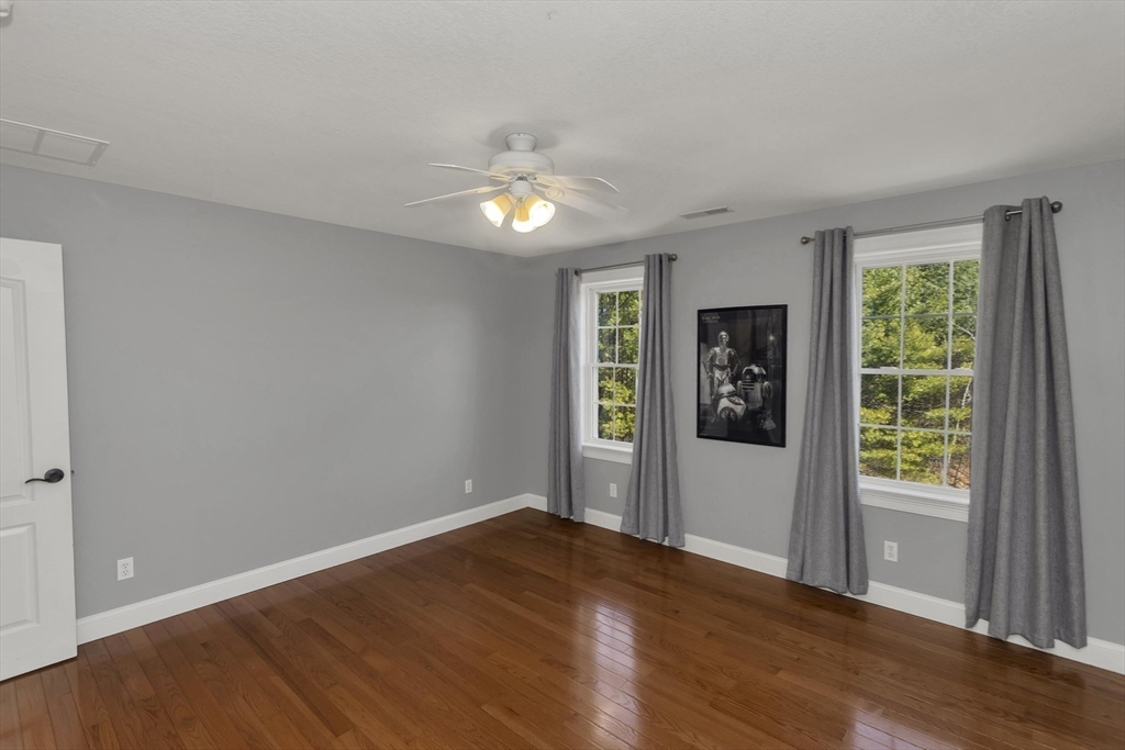 333 Stebbins Street Belchertown, MA 01007 - Photo 24 of 42 a view of an empty room with wooden floor and fan