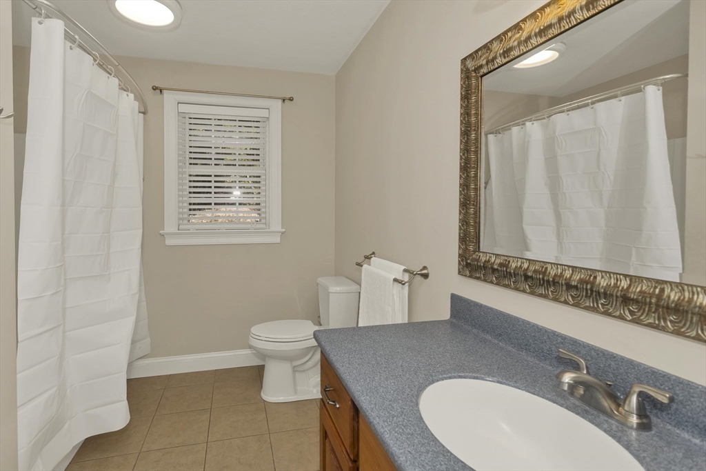 333 Stebbins Street Belchertown, MA 01007 - Photo 27 of 42 a bathroom with a granite countertop sink toilet and mirror