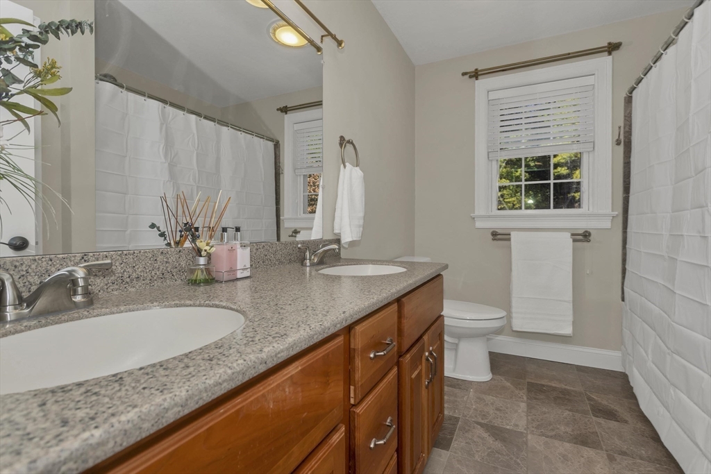 333 Stebbins Street Belchertown, MA 01007 - Photo 33 of 42 a bathroom with a granite countertop sink and a mirror