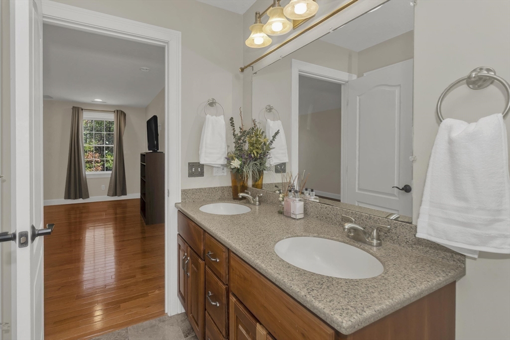 333 Stebbins Street Belchertown, MA 01007 - Photo 34 of 42 a bathroom with a granite countertop sink and a mirror