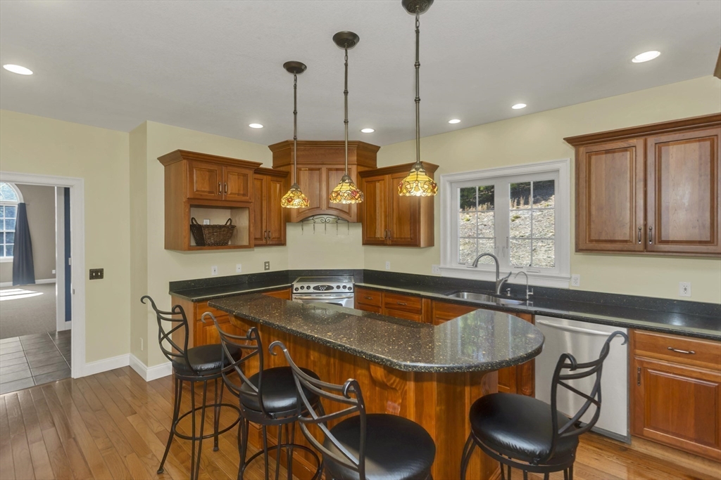 333 Stebbins Street Belchertown, MA 01007 - Photo 8 of 42 a kitchen with a table chairs sink and cabinets
