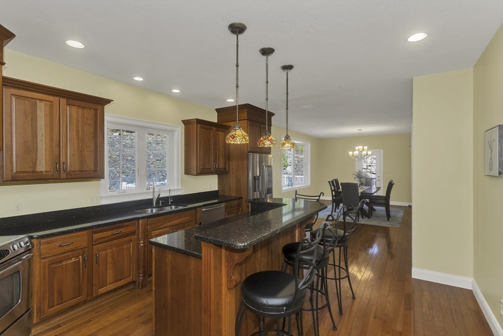 333 Stebbins Street Belchertown, MA 01007 - Photo 9 of 42 a kitchen with granite countertop a sink a counter space dining table and chairs
