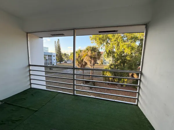 a view of a room with window and a ceiling fan