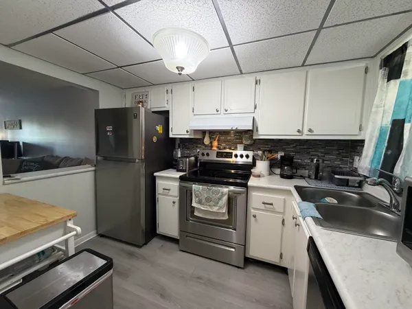 a kitchen with a refrigerator sink and stove