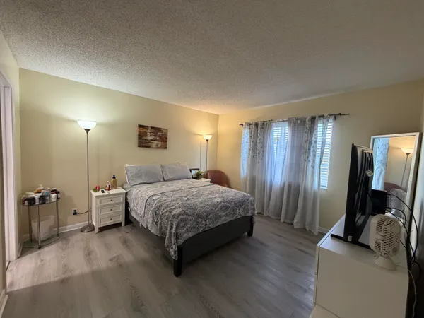 a spacious bedroom with a bed and a couch