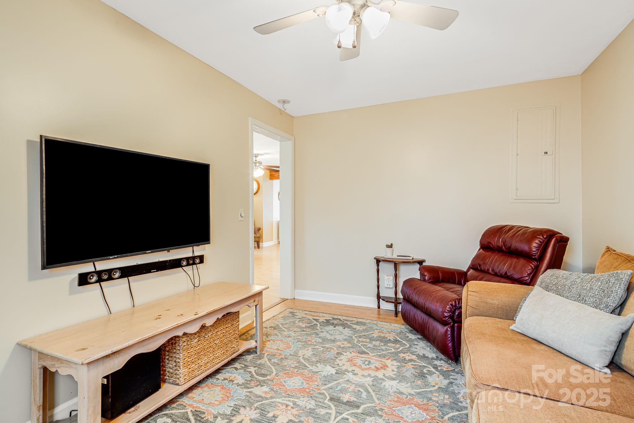 195 Whitmire Road Brevard, NC 28712 - Photo 15 of 30 a living room with furniture and a flat screen tv