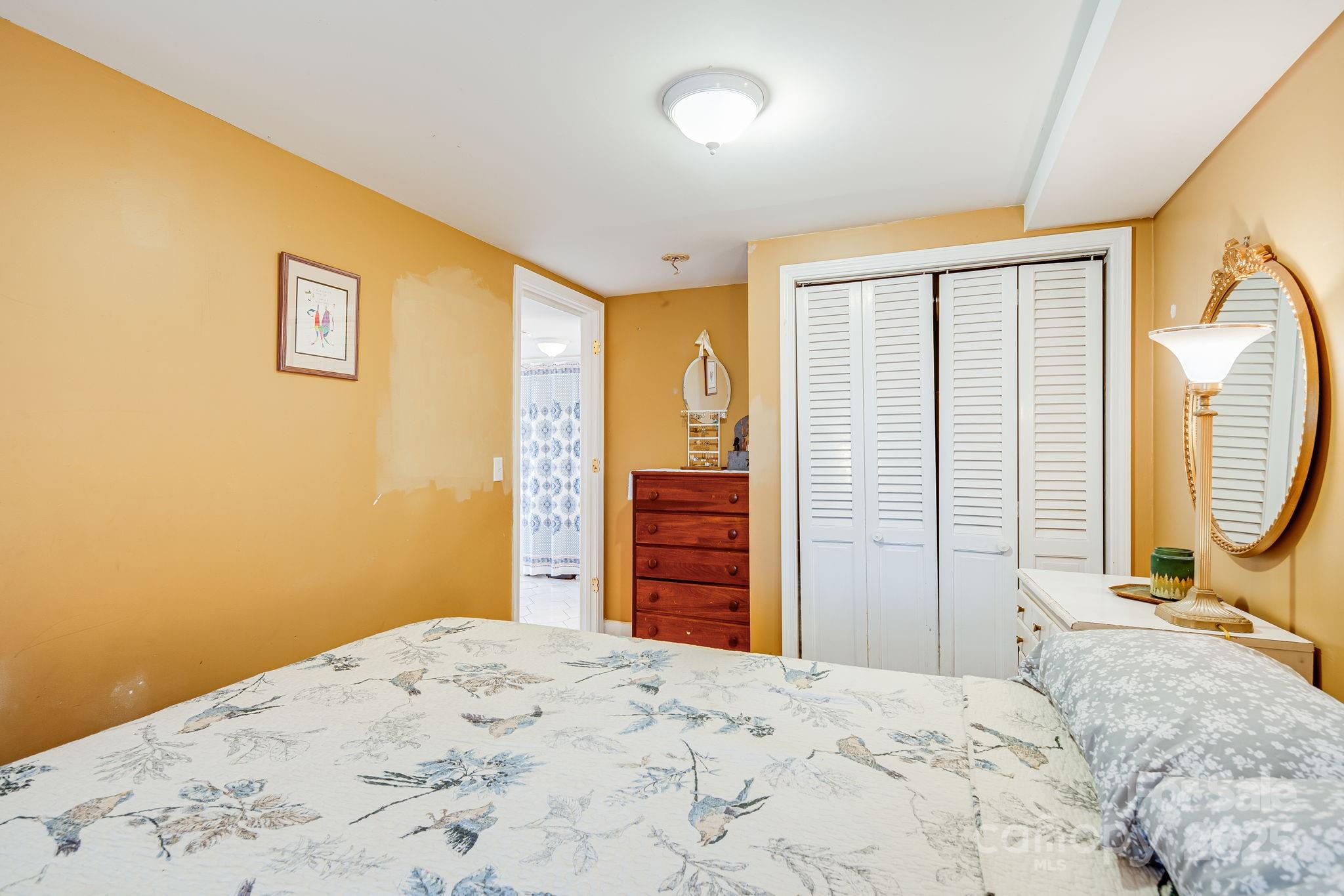 195 Whitmire Road Brevard, NC 28712 - Photo 17 of 30 a bedroom with a bed and wooden floor