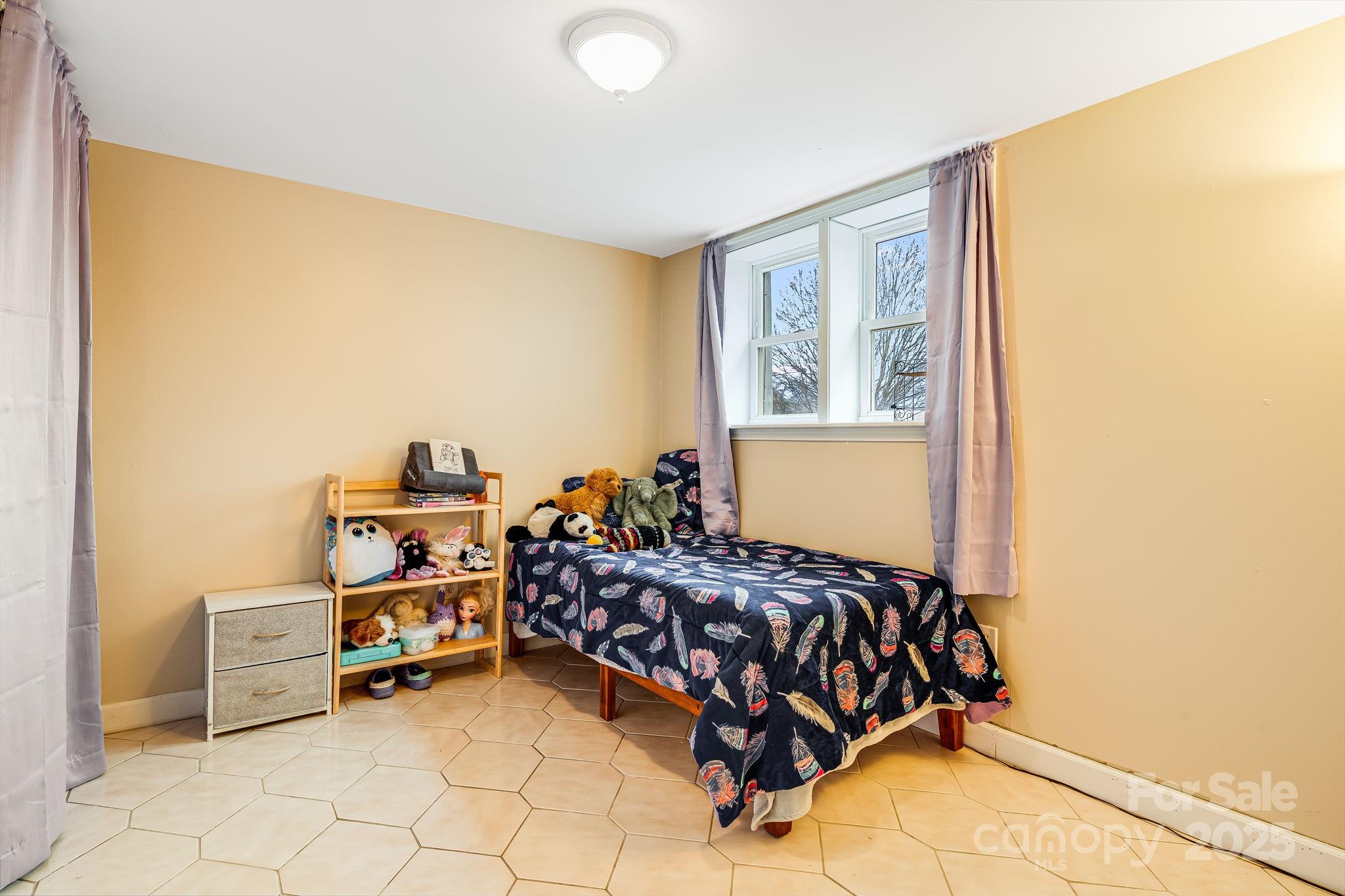 195 Whitmire Road Brevard, NC 28712 - Photo 21 of 30 a bedroom with a bed and a window