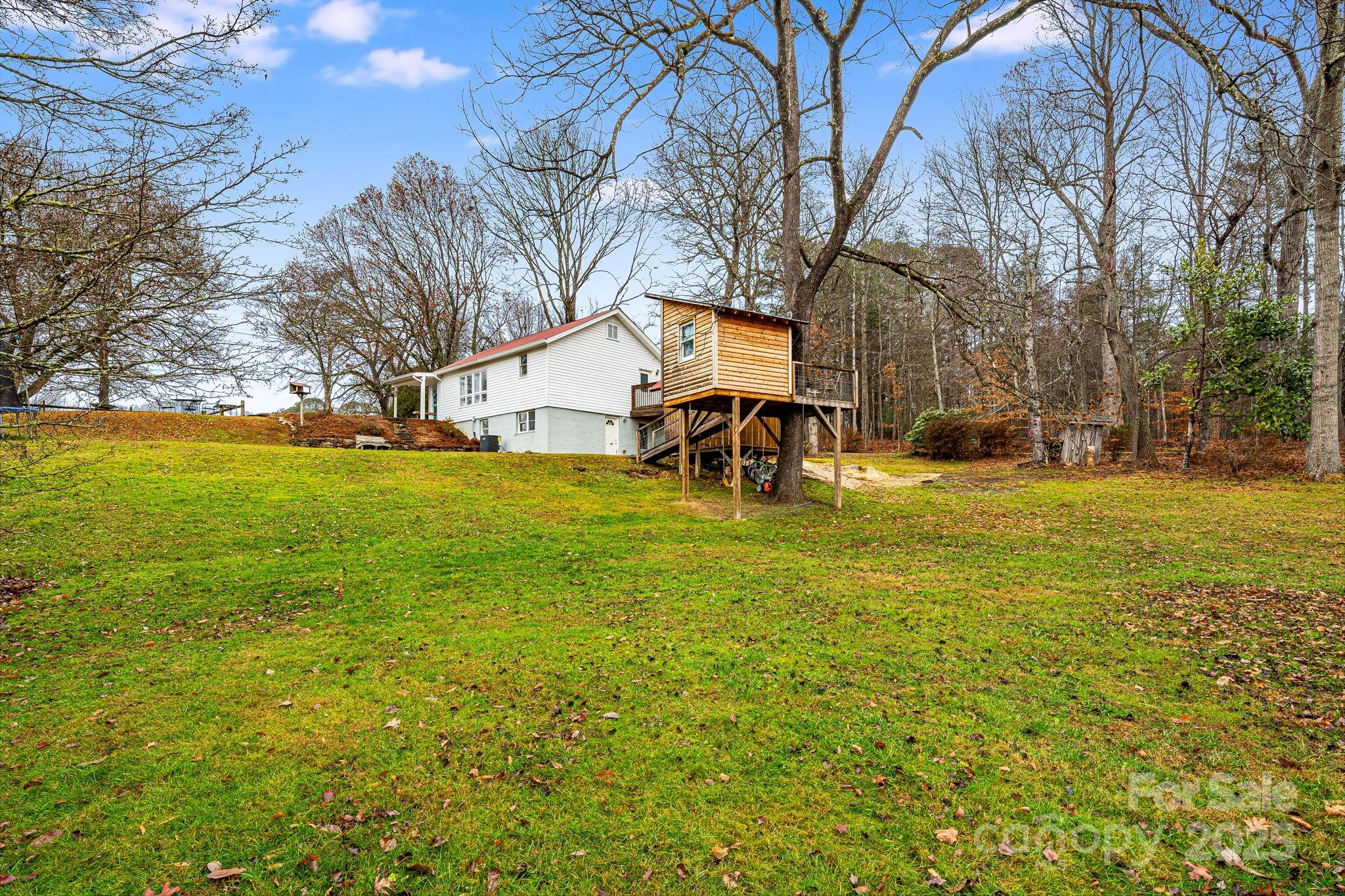 195 Whitmire Road Brevard, NC 28712 - Photo 25 of 30 a view of a house with a yard and sitting area