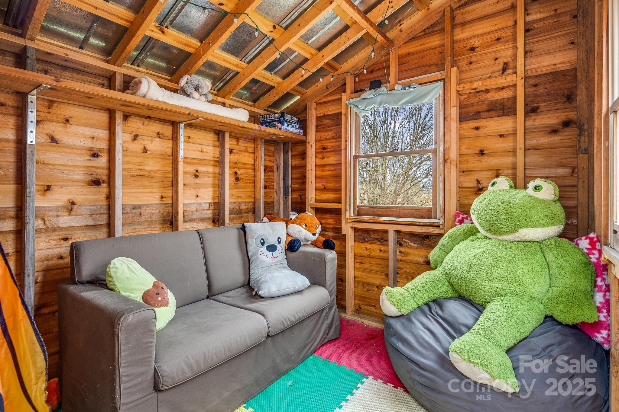 195 Whitmire Road Brevard, NC 28712 - Photo 28 of 30 a living room with furniture and a large window