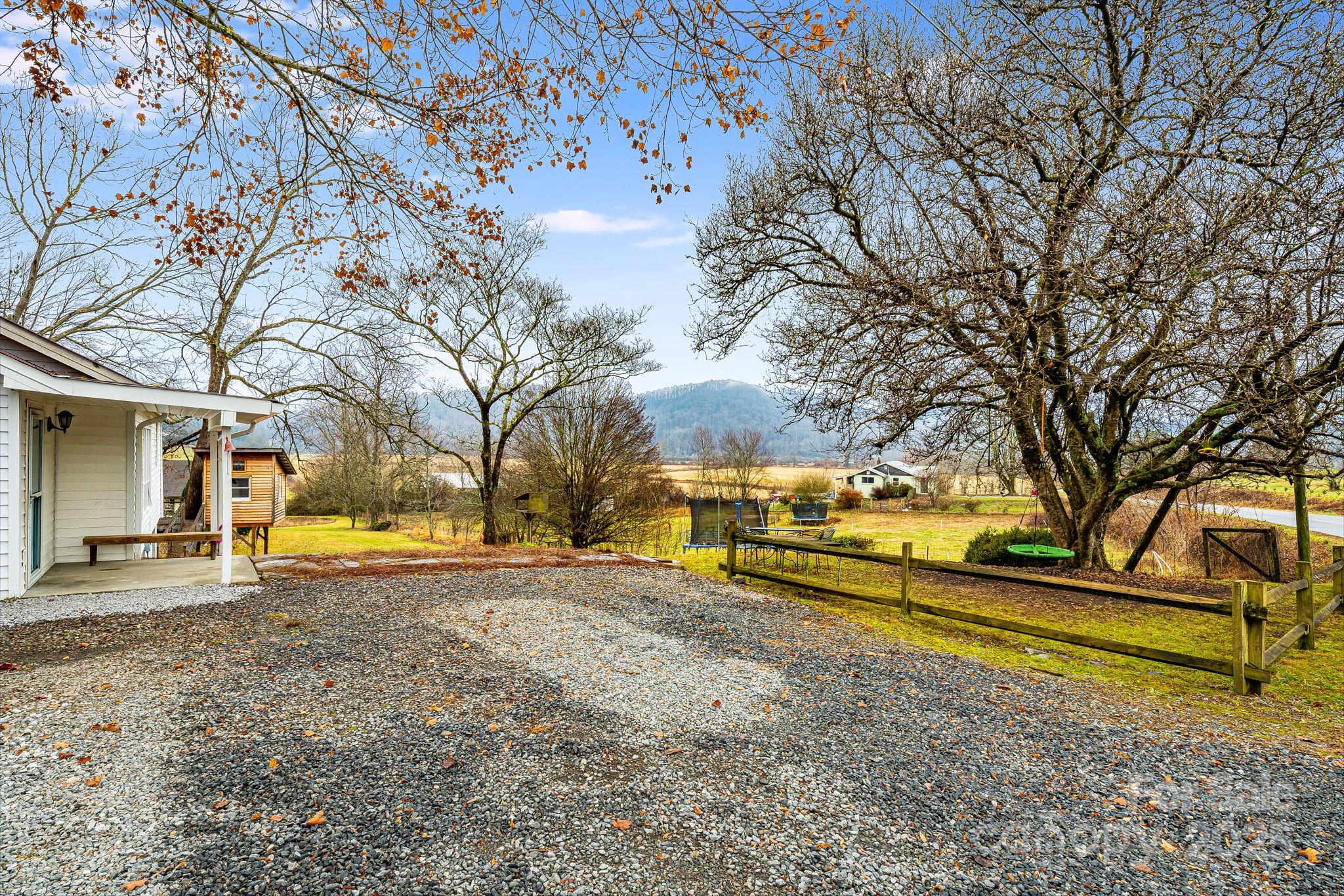 195 Whitmire Road Brevard, NC 28712 - Photo 29 of 30 a view of a house with large trees and a big yard