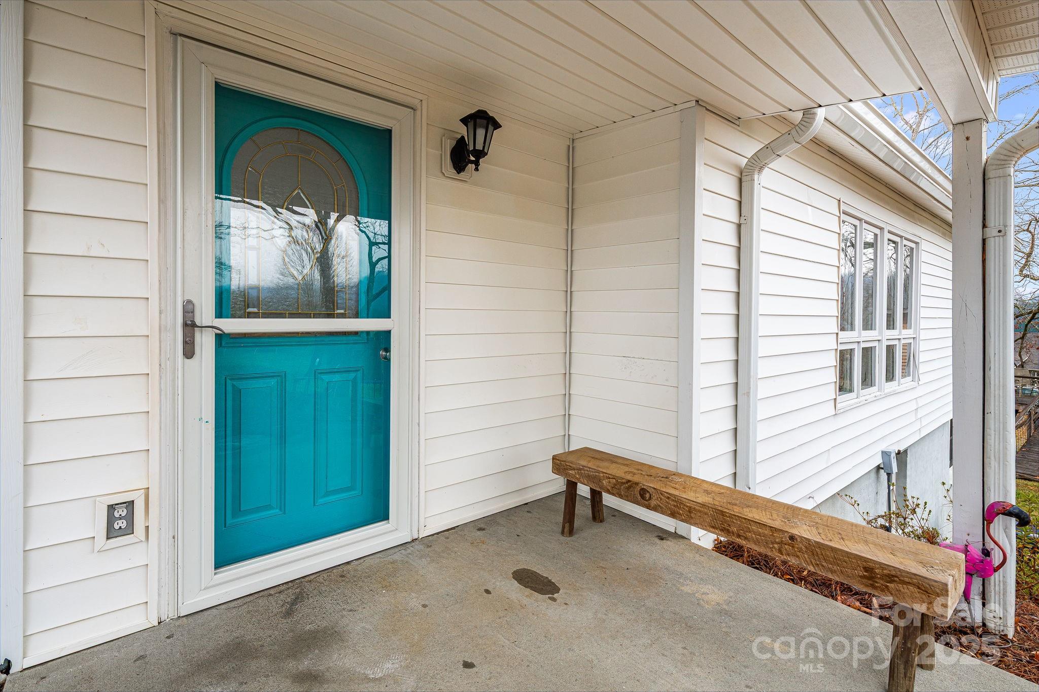 195 Whitmire Road Brevard, NC 28712 - Photo 3 of 30 a backyard of a house with wooden floor and outdoor space