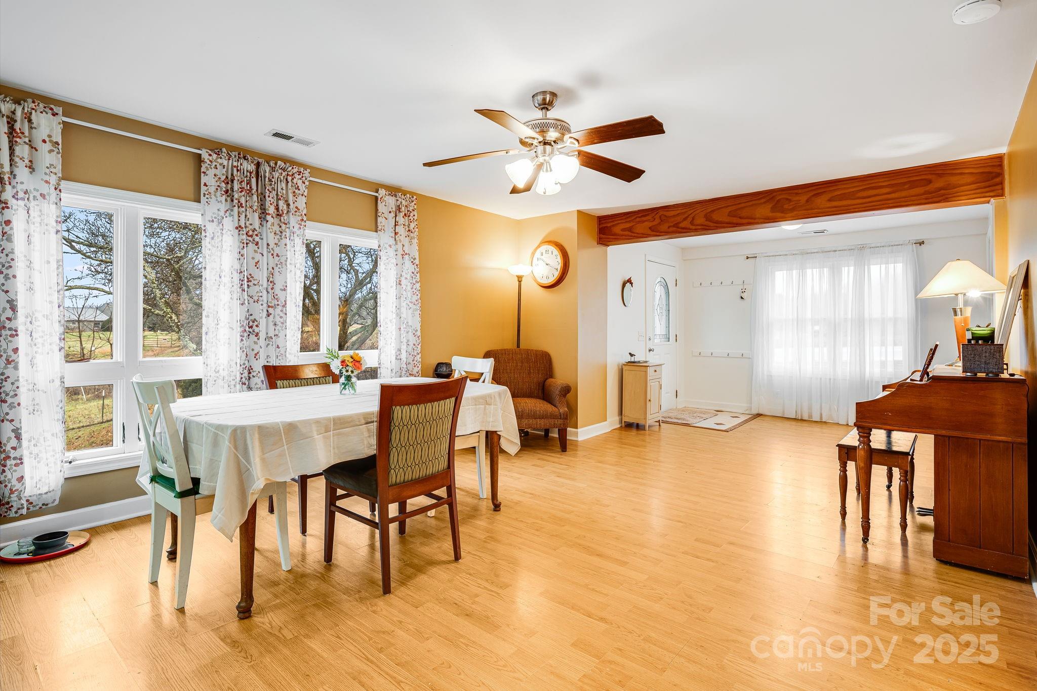 195 Whitmire Road Brevard, NC 28712 - Photo 6 of 30 a view of a a dining room with furniture window and wooden floor