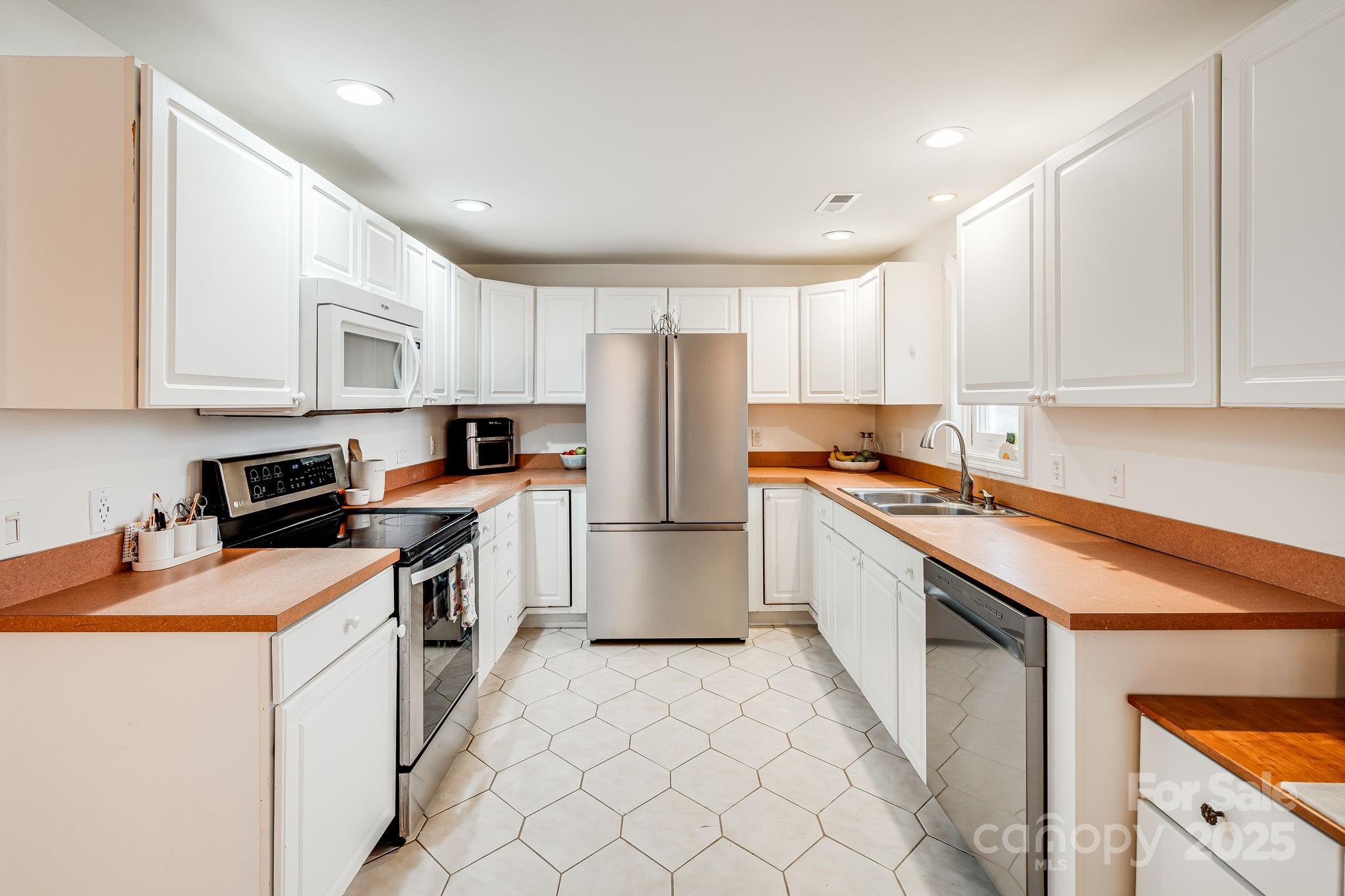 195 Whitmire Road Brevard, NC 28712 - Photo 8 of 30 a kitchen with stainless steel appliances granite countertop a stove refrigerator sink and cabinets
