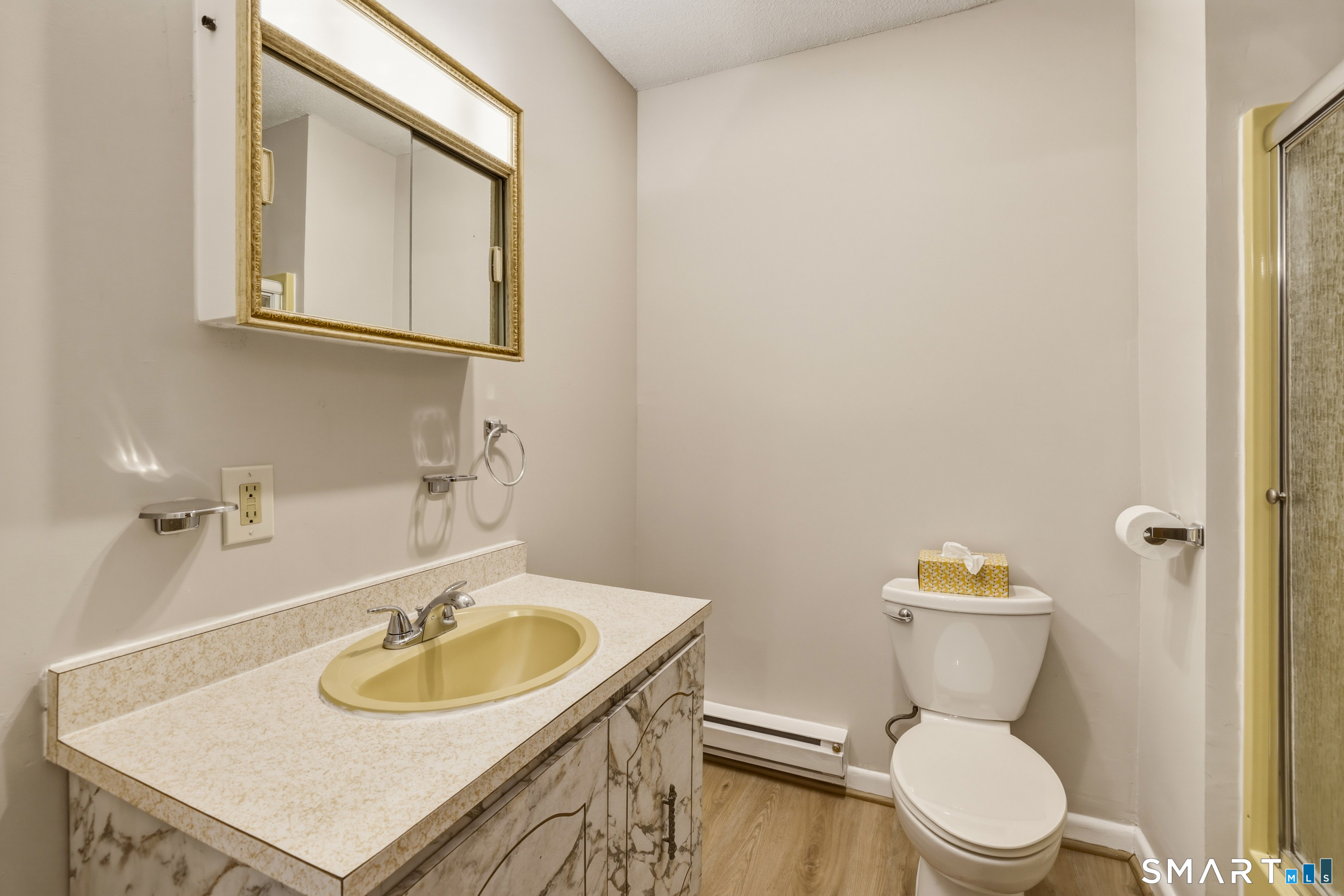 412 South Main Street, Unit 15 Plymouth, CT 06786 - Photo 21 of 28 a bathroom with a sink a toilet and a mirror